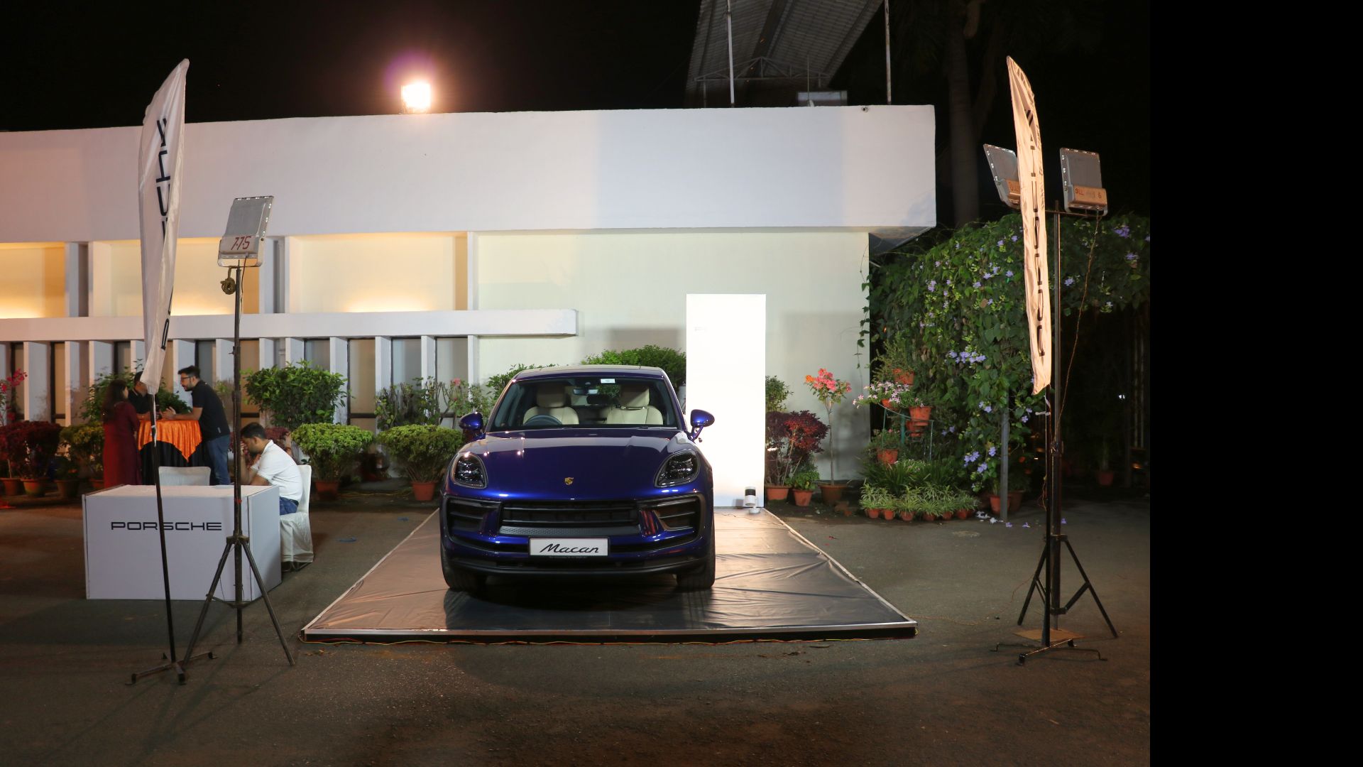 Car staged outside a lit venue at night