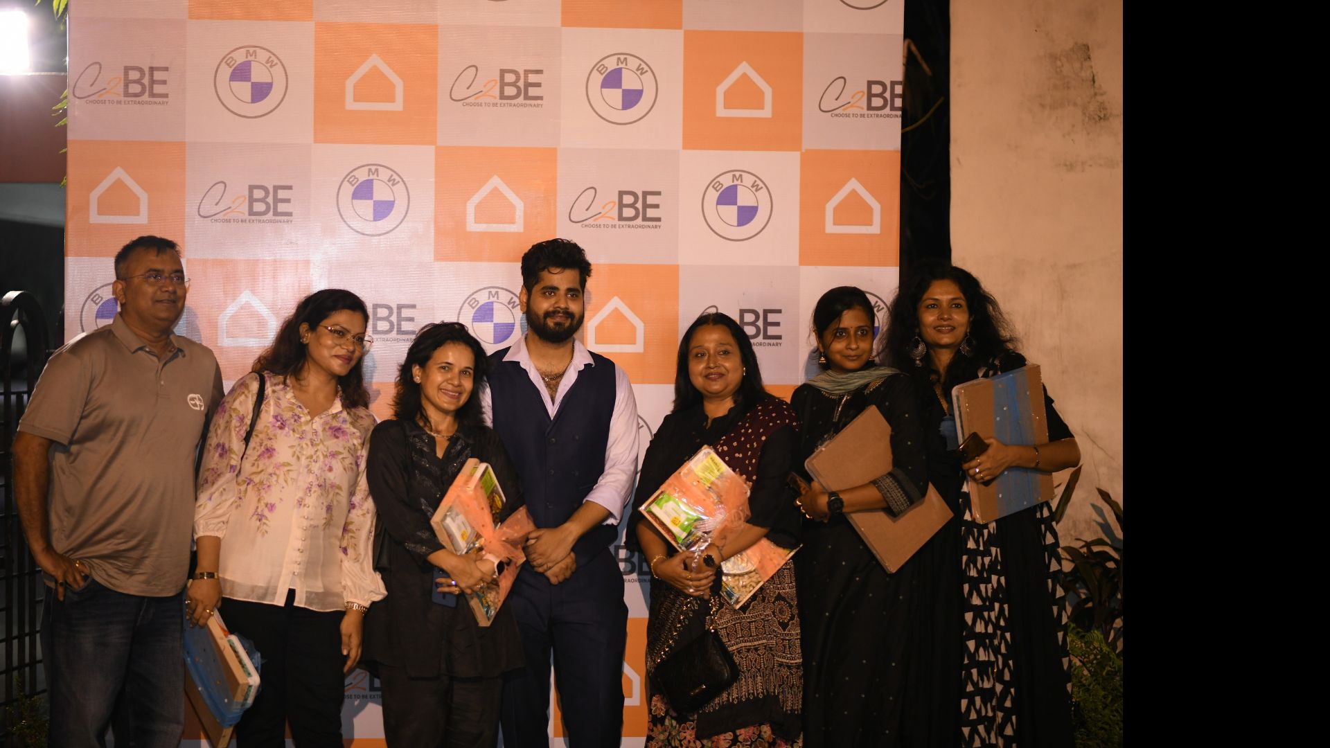 Group at a branded event wall